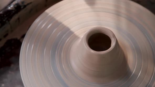 Closeup Shot of Spinning Pottery Wheel with Half-finished Ceramic Vase or Bowl