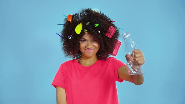 Woman squeezing plastic bottle.