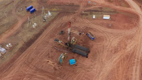 Oil Workers Work with an Oil Rig in an Oil Field alt