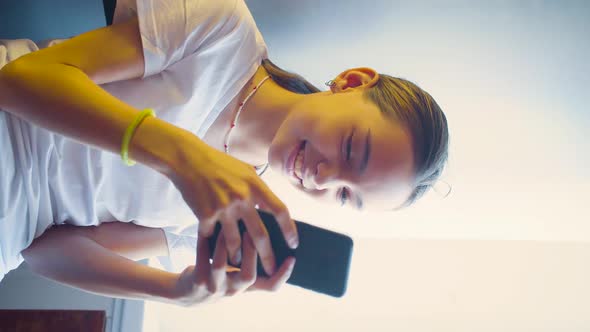 Teenager Girl Playing Video Game Touching Smartphone Screen  She Having Fun at Home