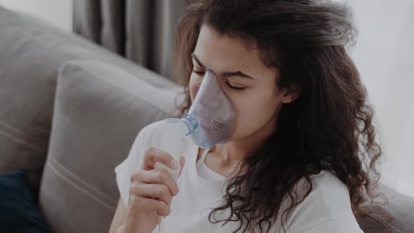 Young African American Woman Putting on Oxygen Mask Having an Asthma alt