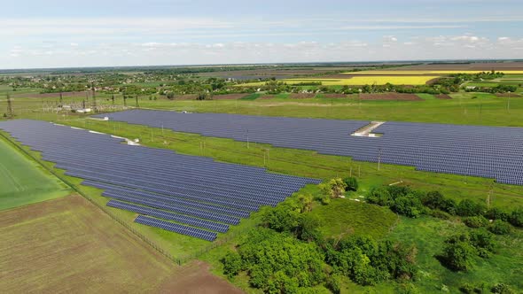 Landscape of a Green Field and a Solar Power Station,  alt