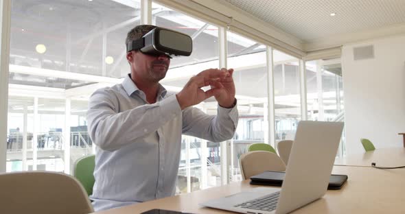 Businessman using virtual reality headset at desk in modern office 4 4k