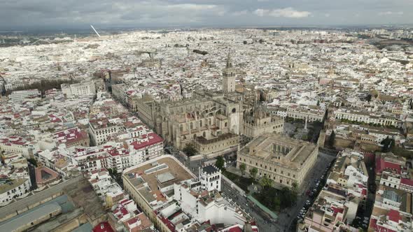 City view of Seville with impressive Seville Cathedral; wide drone pan