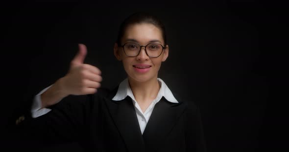 Positive Business Woman Smiles and Gives a Thumbs Up