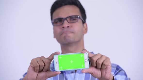 Face of Happy Young Indian Hipster Man Showing Phone alt