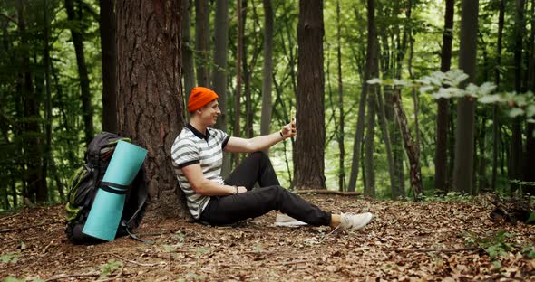 Male Backpack Tourist Video Chat in Forest