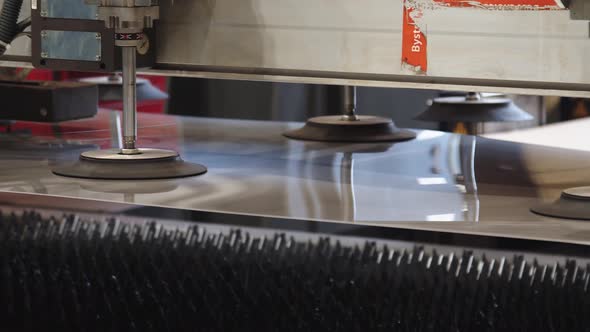 Closeup of Automated Machine Holding and Moving the Glass Sheet with Suckers and Getting It to the