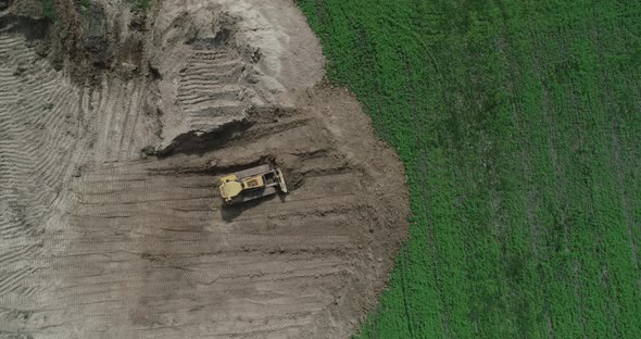 A Crawler Tractor Pushes The Ground With A Bucket Top View  alt