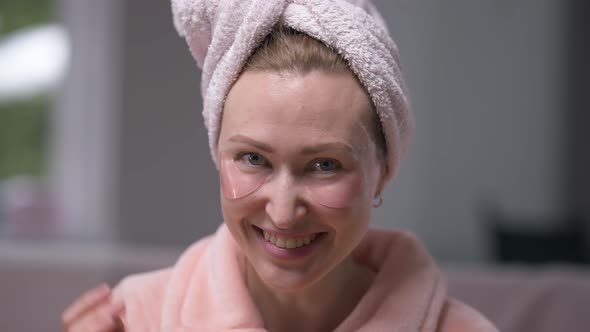 Front View Laughing Woman with Eye Patches Looking at Camera Gesturing Air Kiss in Slow Motion alt