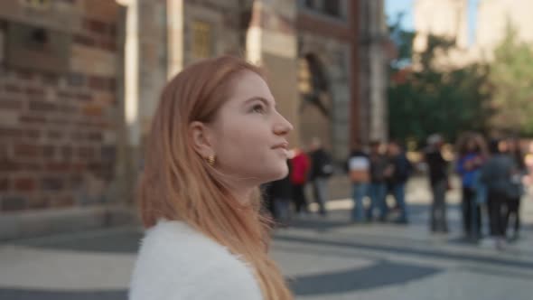 Young Woman Walking In Square In Prague alt