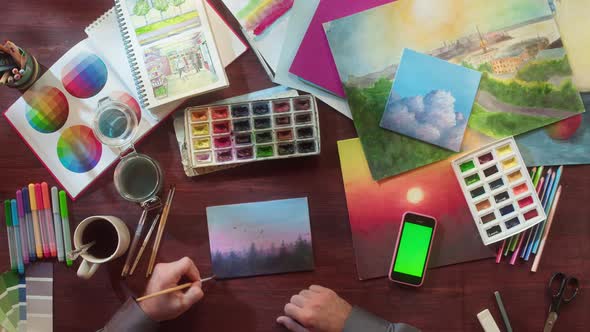 Artist Painting Landscape with Watercolors and Brush Top View alt