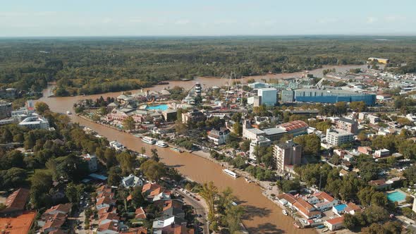 Aerial establishing shot of Tigre river mouth flying towards Paraná delta. Dolly in alt