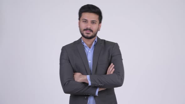 Young Happy Bearded Indian Businessman with Arms Crossed alt