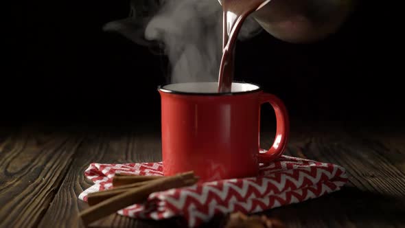Pouring hot chocolate into the red cup