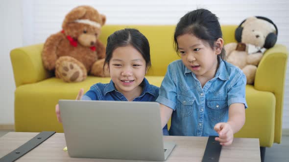 Two Asian girls studying online from home internet, Home Study, Social Distancing