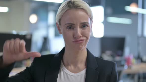 Portrait of Disappointed Businesswoman Showing Thumbs Down alt
