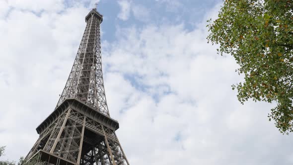 Famous lattice construction of Eiffel tower and symbol of France in front of cloudy sky 4K 2160p Ult alt