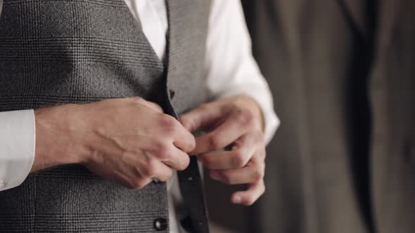 Buttoning Jacket with Hands Close Up Man in Suit Fastens Buttons on His Jacket Preparing to Go Out alt