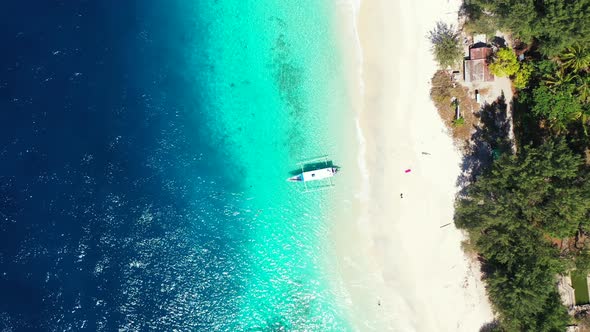 Philippine traditional long boat anchoring on white sandy shore beach ...