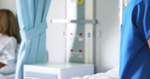 Doctor noting down the pulse rate of the patient alt