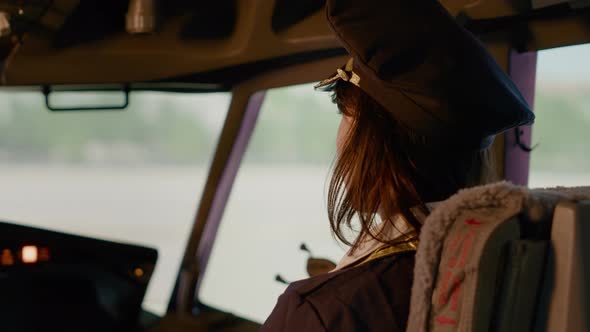 Portrait of Female Copilot in Aviation Uniform Flying Airplane alt