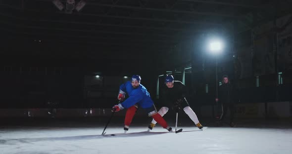 2 Hockey Players Fighting for Puck, Legs, Skates Close View alt