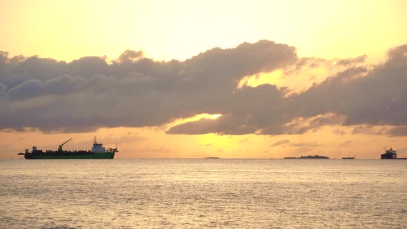 Cargo Ship At Golden Sunrise Horizon Ocean New Economic Vessel