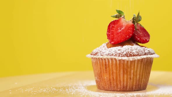 Very Tasty Dessert Cupcake with Strawberries Rotates on a Yellow Background and Decorates Tasty