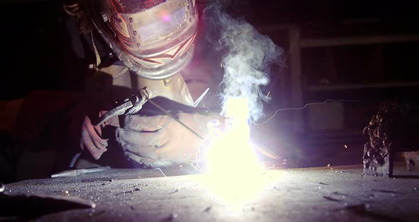 Welder working on a piece of metal alt