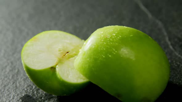 Halved green apple on concrete background 4K 4k alt