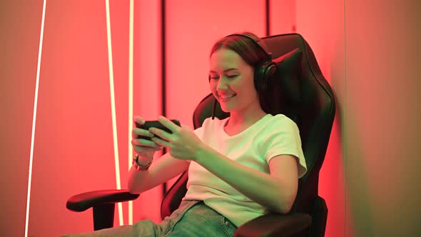 Portrait of Addicted Crazy Funny Funky Teenager Girl Use Her Smartphone Play Game alt