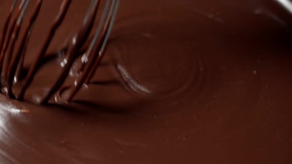 Mixing Stirring Melted Liquid Dark Chocolate with Whisk Confectioner Prepares Dessert Topping alt