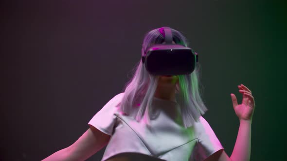 Addicted Woman Gaming Moving in Invisible Space Using VR alt