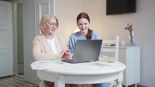 The Daughter and Her Elderly Mother Say Goodbye to the Interlocutor Via Video Communication alt