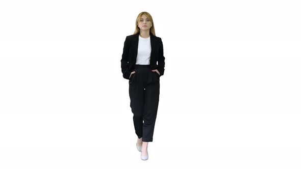 Walking Businesswoman with Hands in Pockets on White Background. alt