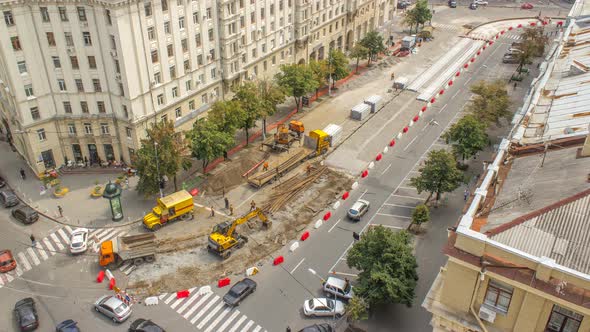Orange Construction Telescopic Mobile Crane Loading Old Tram Rails Into Truck Timelapse alt