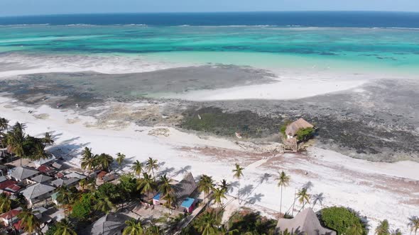 The Rock Restaurant in Ocean Built on Stone at Low Tide on Zanzibar Aerial View alt