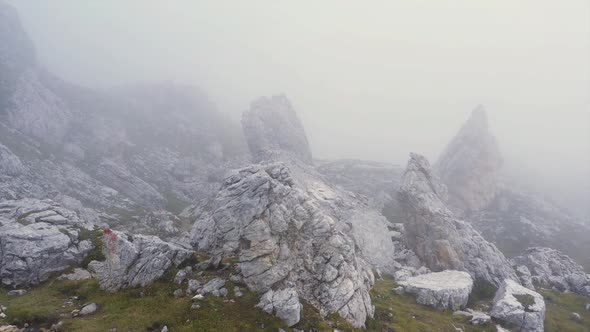 Drone flight over the foggy rocks of the Dolomites