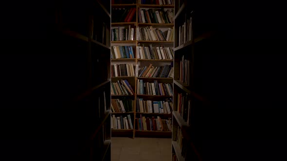 Old Library. The Camera Moves Along Two High Bookshelves. Cinematographic Frame