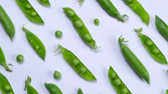 Rotating Young Green Peas on White Background Healthy Food Concept Trendy Vegetable Background alt