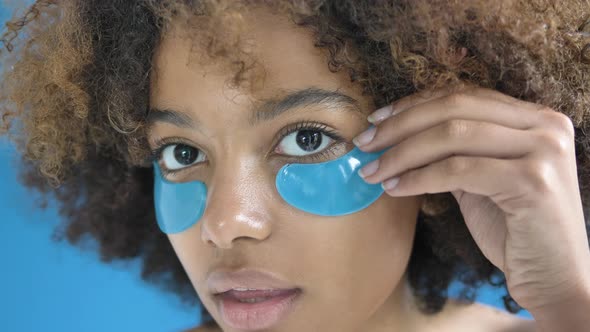 Professional African American Model Applies Patches on Face alt