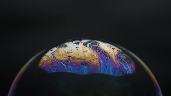 Soap bubbles isolated on black background. Abstract soap bubbles with colorful reflections. alt