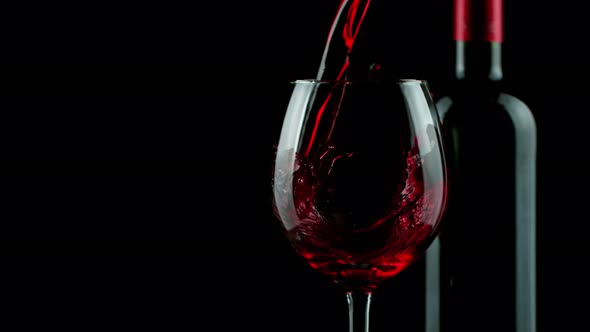 Super Slow Motion Shot of Pouring Red Wine on Black Background at 1000Fps alt