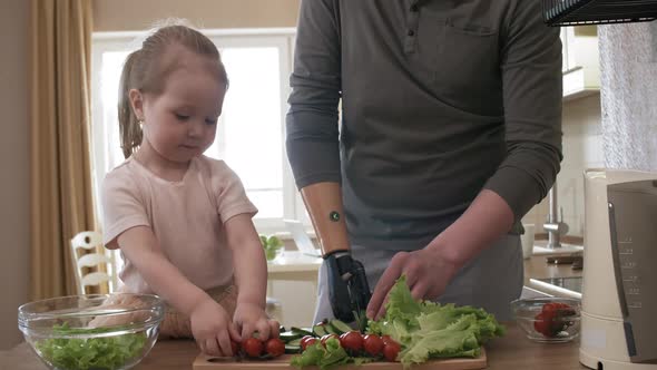Caucasian Amputee Father Making Salad with Daughter alt