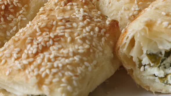 Thin sheets of dough rolls baked with filling close-up 4K 2160p 30fps UHD tilting footage - Served o alt