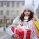 A Woman is Standing in the City Center During a Snowfall - VideoHive Item for Sale