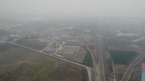 Rural Poor Village Outside Beijing with Farmland and Train Tracks During Extreme Pollution Day alt