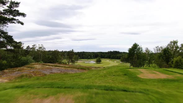 Unrecognizable professional golfer hits ball on golf course of Molndal near Gothenburg, Sweden. Aeri alt