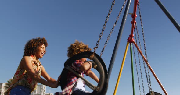 Mother and son having fun at playground alt